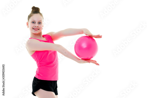 little girl is engaged in fitness with a ball.