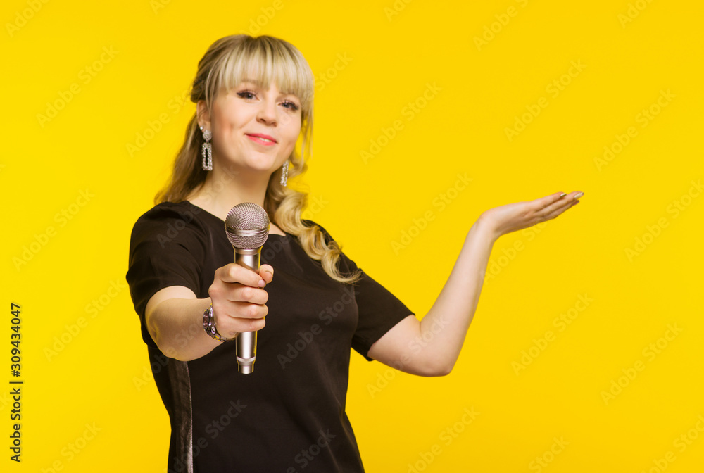 Presentation, public speech, conference, broadcasting, advertising. Cheerful young businesswoman, reporter, TV presenter holding microphone isolated bright yellow background. - obrazy, fototapety, plakaty 