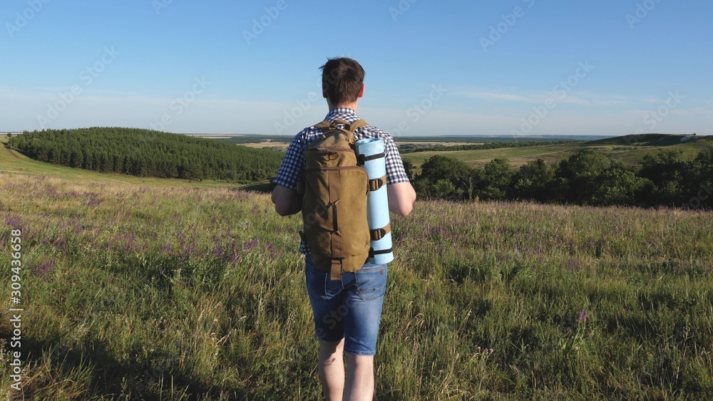 travelers admire the beautiful scenery and nature. teamwork of tourists. travelers go with backpacks through meadow. Family of tourists with children in the countryside. movement to victory.