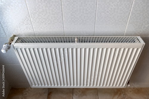 Wallpaper Mural White metal heating radiator mounted on a wall in room interior. Torontodigital.ca