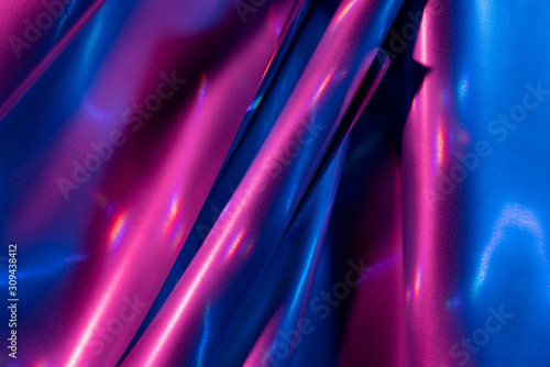 Reflection of light on holographic foils with neon lighting photo