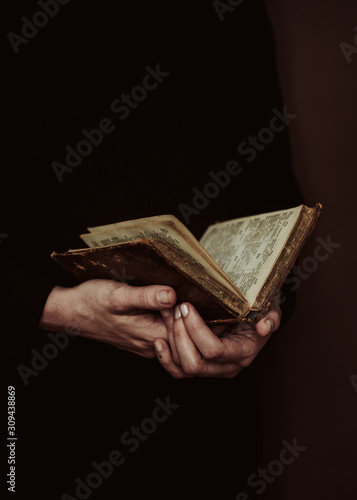 anonymous woman reading a old book photo
