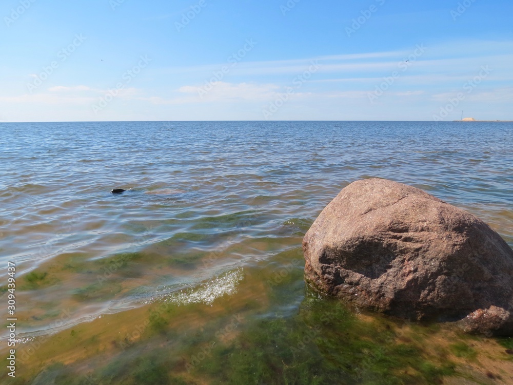 Boulder, waves, seaweeds