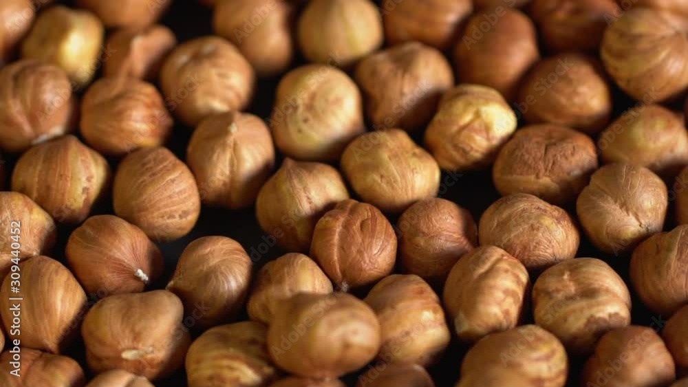 Нazelnut close up. product rich in minerals and vitamins. Нazelnut turns in a shot. Hazelnut kernels rotating. Hazelnut close up lies under beams of the sun. Macro 4K Нazelnut close up. product rich in minerals and vitamins. Нazelnut turns in a shot. Hazelnut kernels rotating. Hazelnut close up lies under beams of the sun. Macro 4K