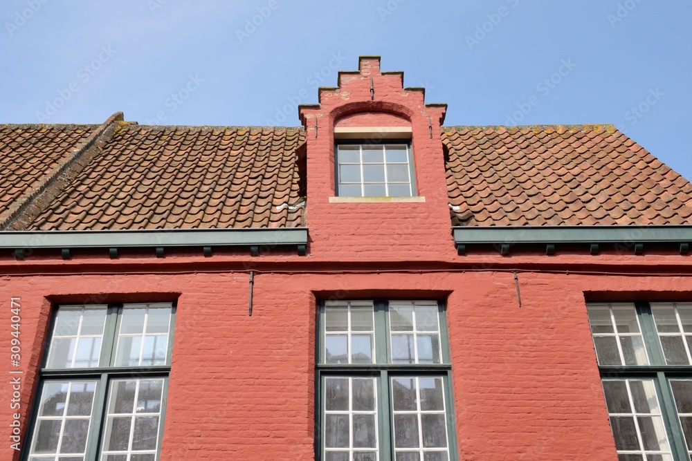 Tile roof  in reddish building of Brugge, Belgium