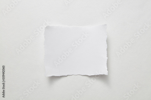 Empty sheet of paper presented on a gray paper background with copy space for text. Layout for your ideas. Top view
