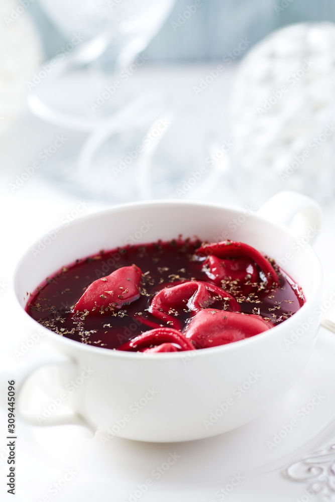 Traditional Christmas Borscht (Barszcz) with mushroom dumplingson bright background. Traditional Christmas Borscht (Barszcz) with mushroom dumplingson bright background.