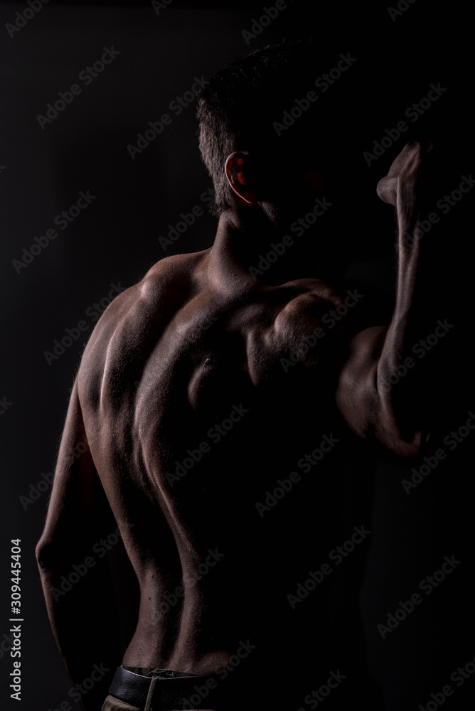 Fototapeta premium Strong athletic man on black background, Fitness shaped muscle man posing 