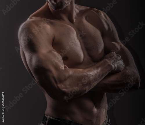 Strong athletic man on black background, Fitness shaped muscle man posing 