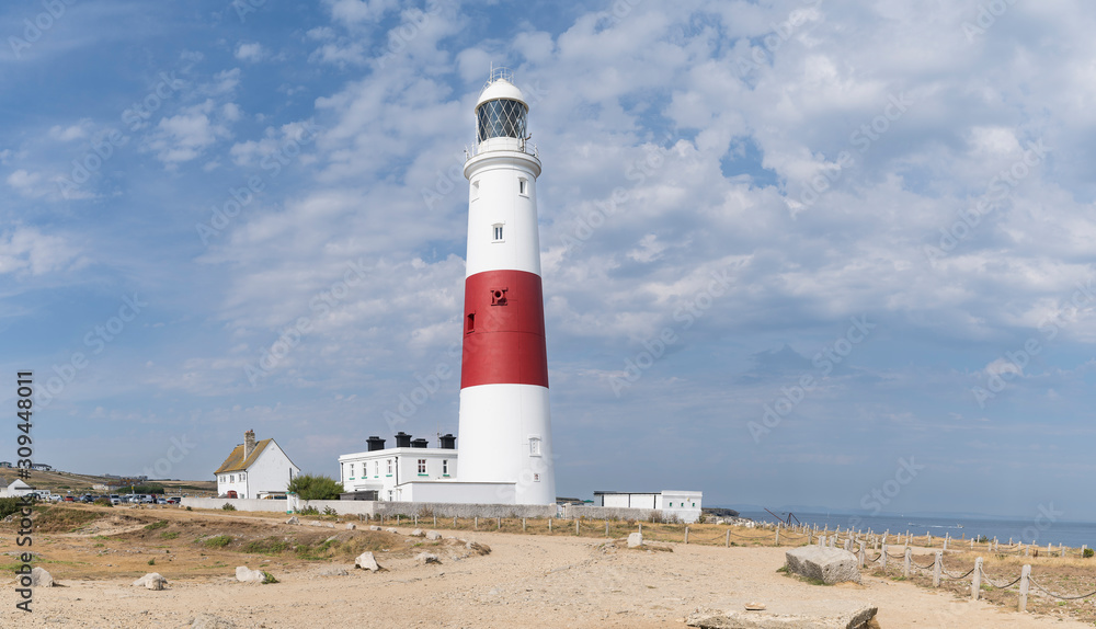 Panoramic view of the Isle of Portland bill lighthouse near Weymoth Dorset coast England UK with a cloudy sky and the ocean in the summer