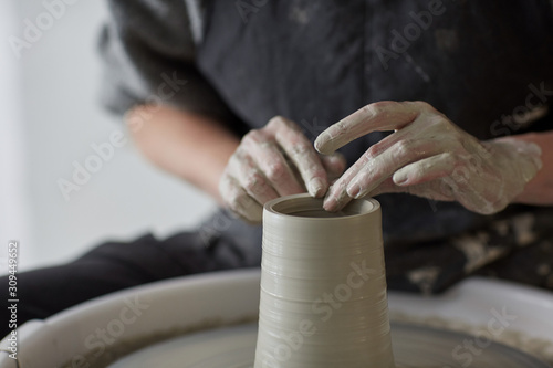 Female hands at work with the potter wheel