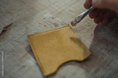 Man Working At Manufacture Of Craft Leather Products photo