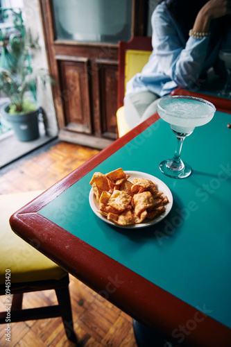 Served snack and margarita cocktail on table photo