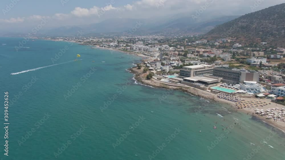 Aerial panorama on beach and blue sea. People swim, enjoy life and summer holidays, Crete, Greece Aerial panorama on beach and blue sea. People swim, enjoy life and summer holidays, Crete, Greece