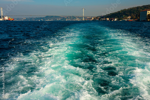 Waves made by ship engine on Bosphorus strait. Istanbul, Turkey photo