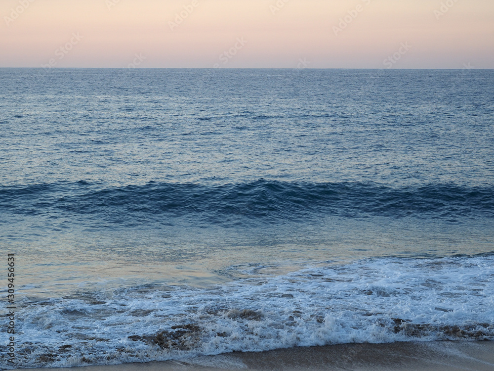 Sandy shore atlantic ocean at beautiful sunset. Dominican Republic.