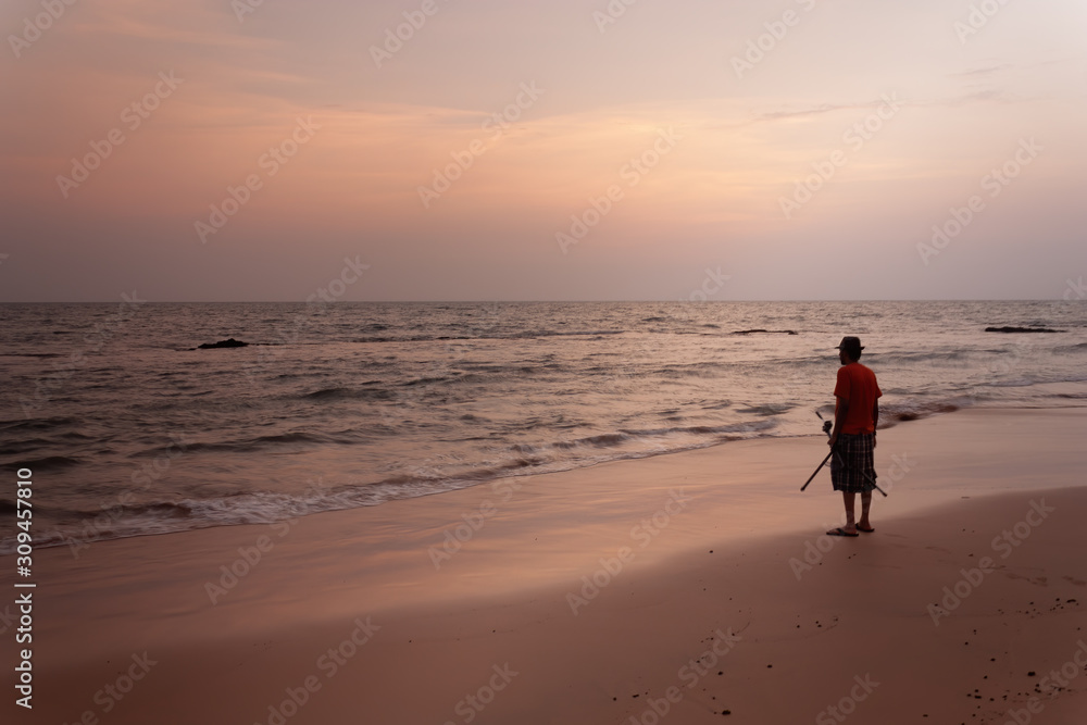 Susnet at Anjuna beach goa with a man on the beach