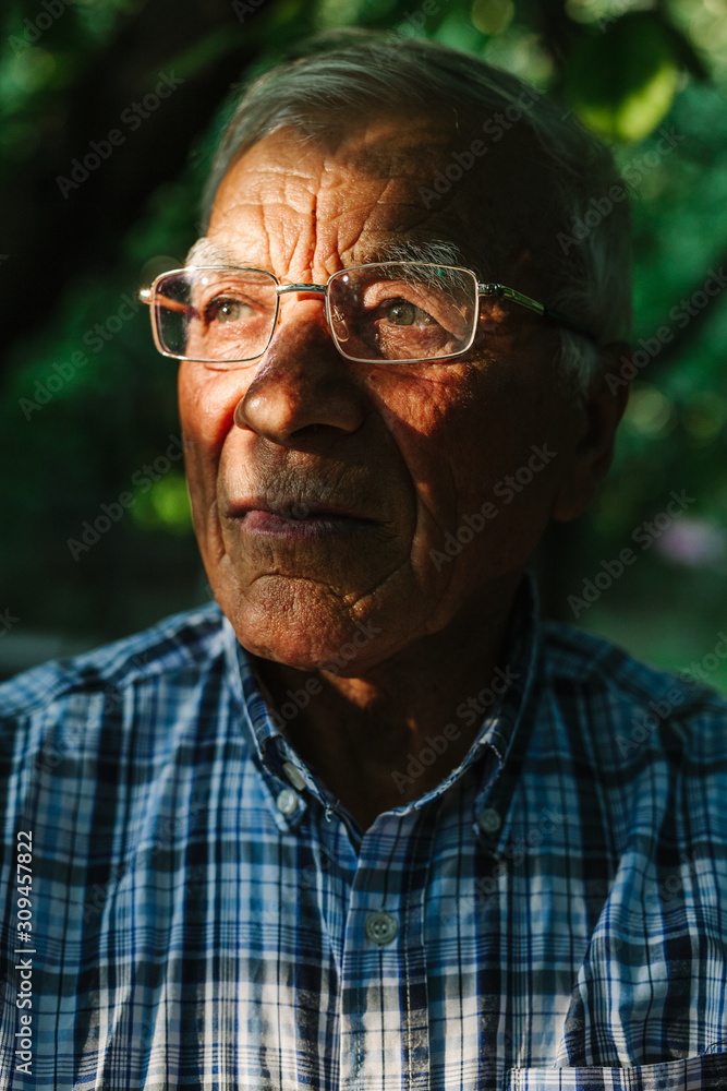 Portrait of old man in spots of sunlight Portrait of old man in spots of sunlight