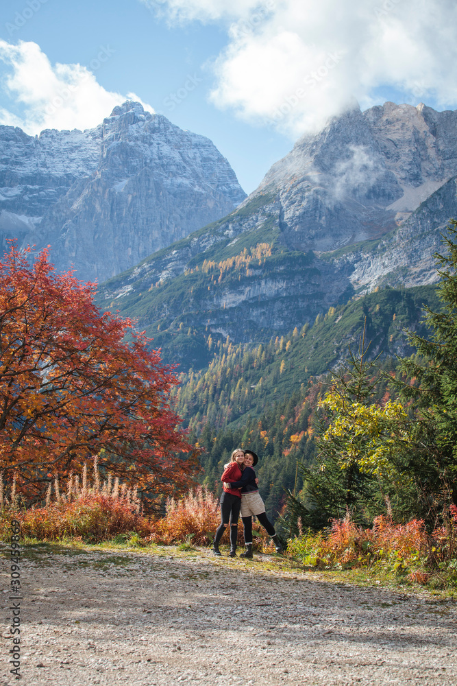 Fototapeta premium Two happy Sisters Hugging in the Autumn Alps