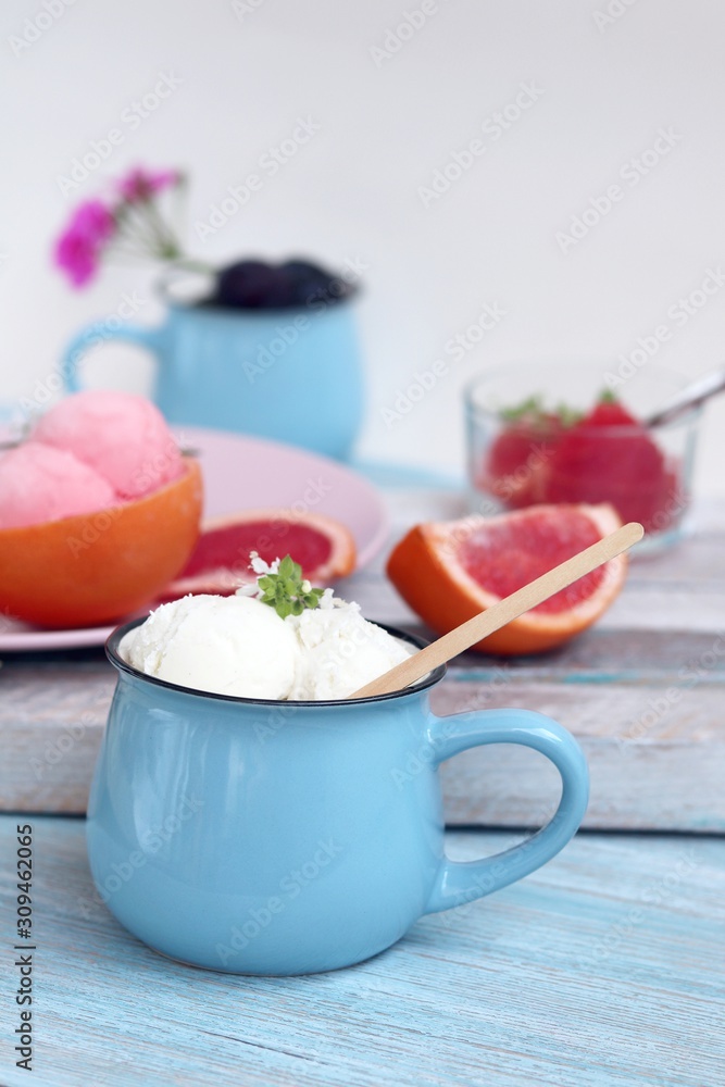 Natural ice cream, grapefruit, basil on a wooden table, tasty and healthy dessert, seasonal food Natural ice cream, grapefruit, basil on a wooden table, tasty and healthy dessert, seasonal food