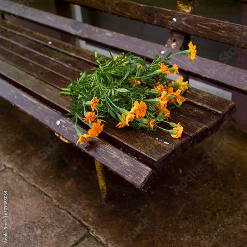 Abandoned bouquet on the  bench photo