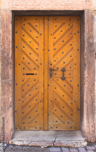 Wooden doors to the house with forging