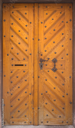 Wooden doors to the house with forging