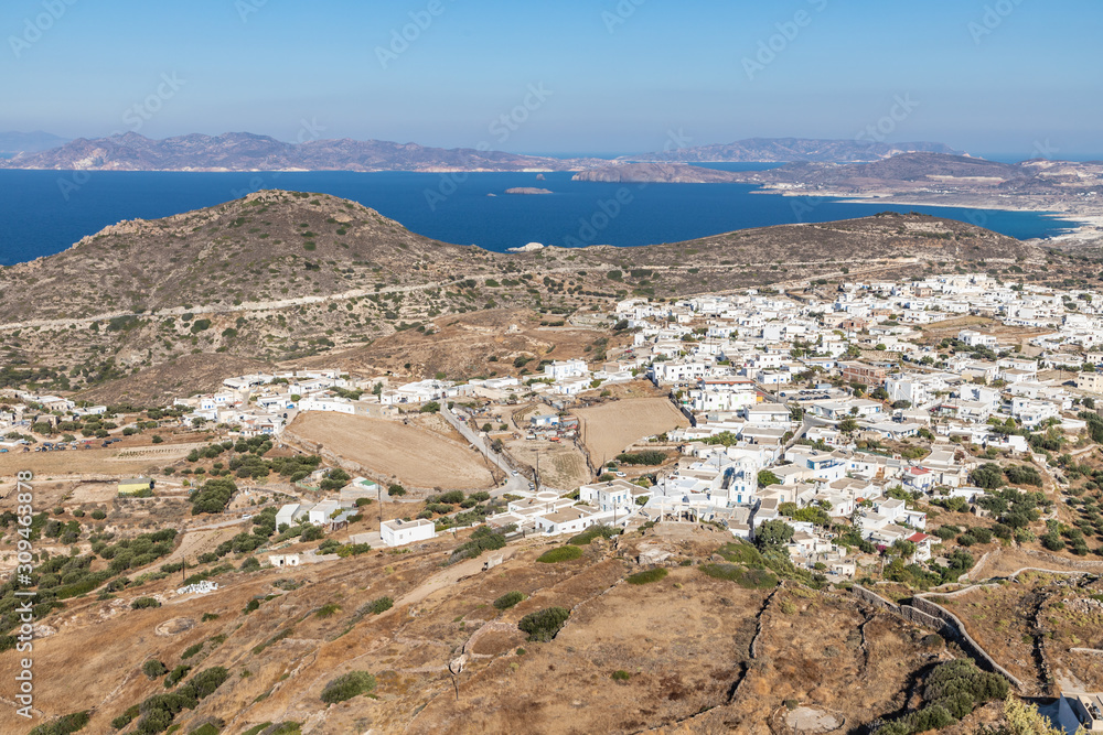 Aerial view with roads, beaches, cliffs and houses in Plaka village