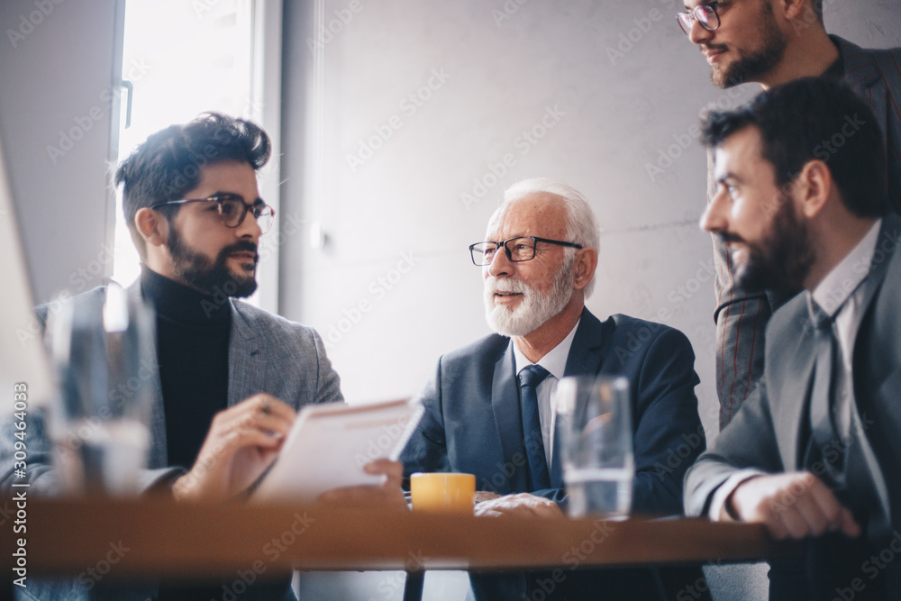 A senior manager with his young managerial team discussing business at his office. A senior manager with his young managerial team discussing business at his office.