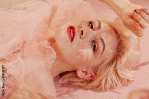 From above portrait of beautiful young blond woman with red lips