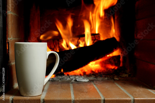 A Cup of hot coffee by fireplace