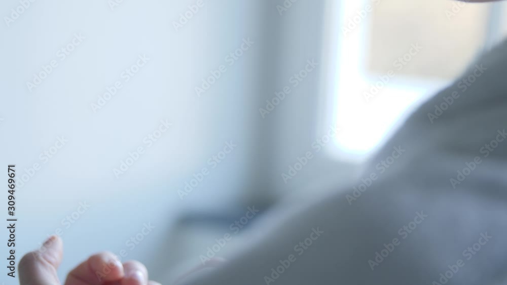 Caucasian man folding hands and looking at nails in day-light close-up Caucasian man folding hands and looking at nails in day-light close-up