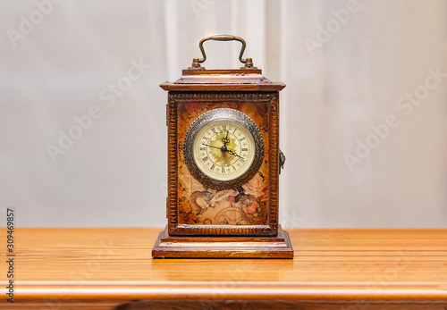 Fotografie Square wooden vintage clock on a shelf