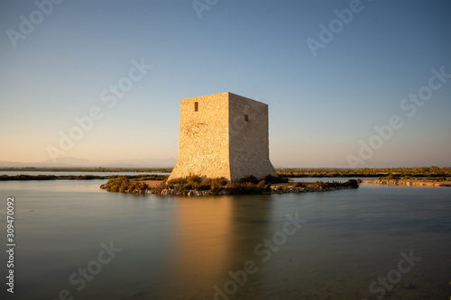Old tower amidst Santa Pola salt marsh at sunset, Costa Blanca, Alicante, Spain