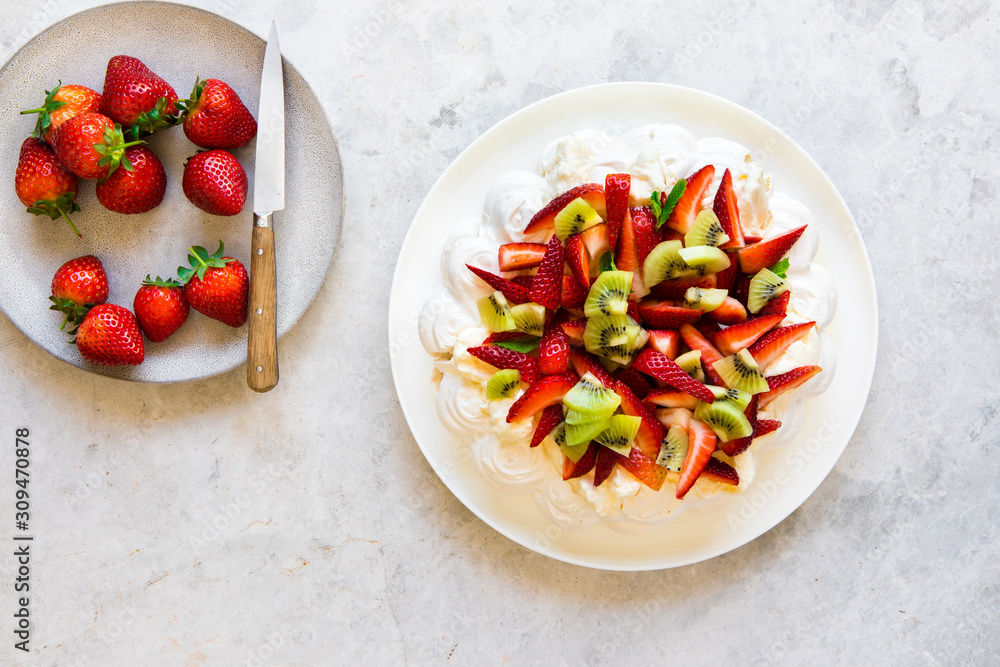 Pavlova dessert with strawberries, kiwi fruit and cream Pavlova dessert with strawberries, kiwi fruit and cream