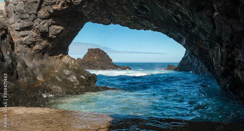 natural arch in rock and waves
