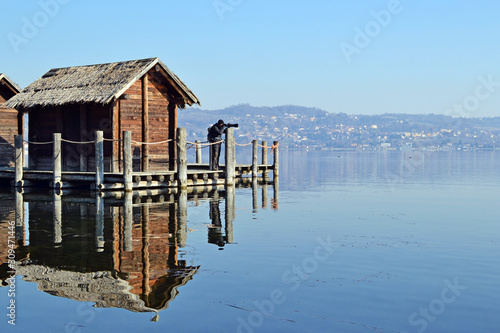 photographer on ancient lake dwellings in Viverone Lake, Piedmont. Italy photo