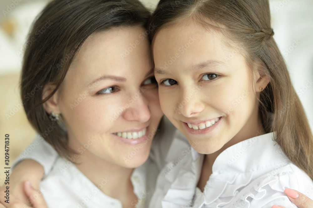Beautiful young mother and cute little daughter posing Beautiful young mother and cute little daughter posing