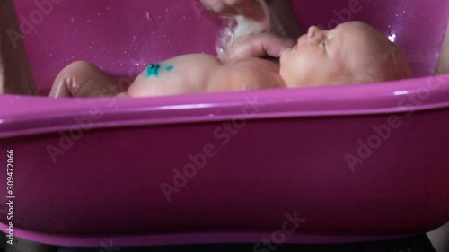 bathing a newborn baby,newborn baby girl bathe in the bathroom