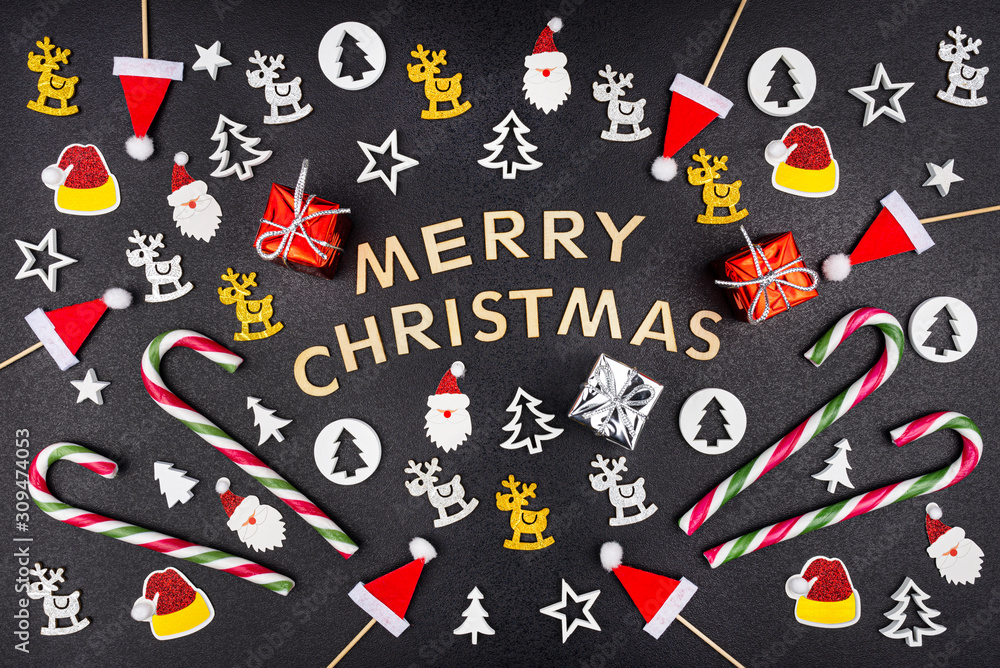 The inscription Merry Christmas on a black rough background around which there are various types of Christmas decorations. The inscription Merry Christmas on a black rough background around which there are various types of Christmas decorations.