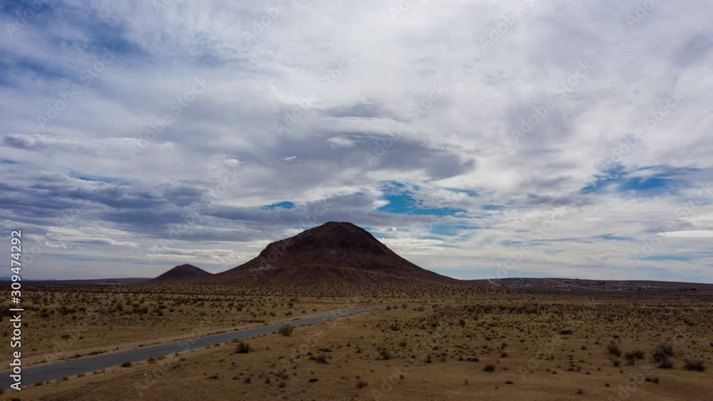 Hyperlapse moving toward Mojave Desert rock hill on cloudy day Hyperlapse moving toward Mojave Desert rock hill on cloudy day
