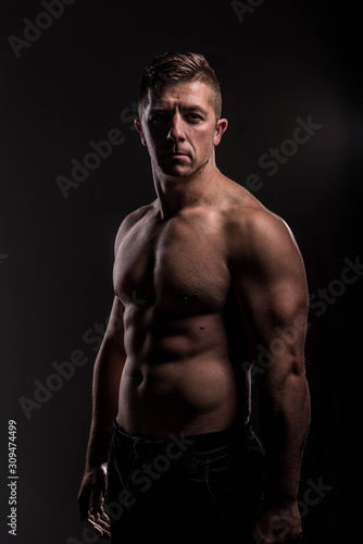Strong Athletic Man Fitness Model Torso showing big muscles over. © John Ilich