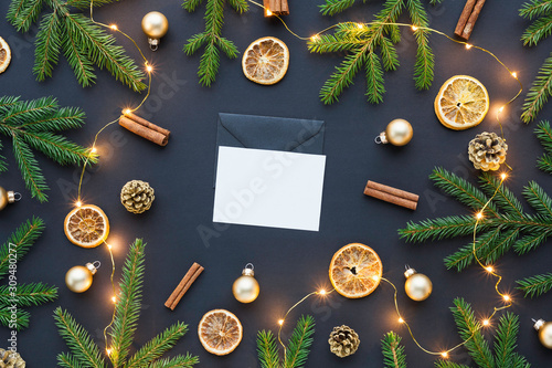 Beautiful christmas top view photo with empty white card in the center - mockup for your design and lots of festive decorations around