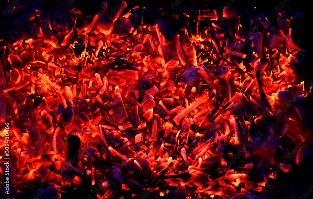 abstraction yellow-red coals smolder against the background of the night, the remains of firewood abstraction yellow-red coals smolder against the background of the night, the remains of firewood