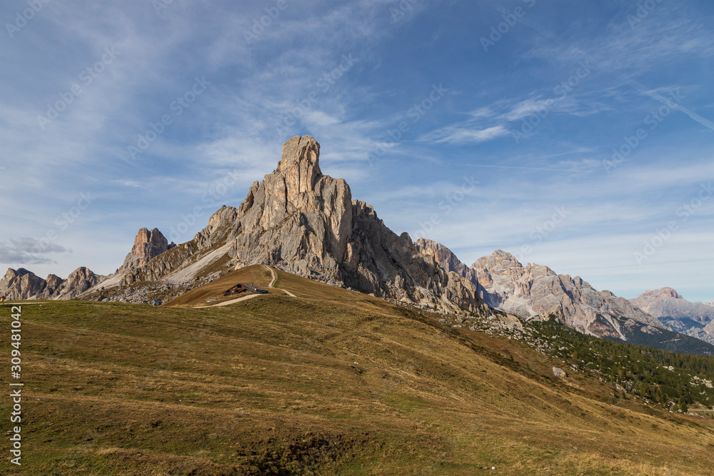 The Giau Pass in the Italian Dolomites in beautiful weather with white clouds in the blue sky.