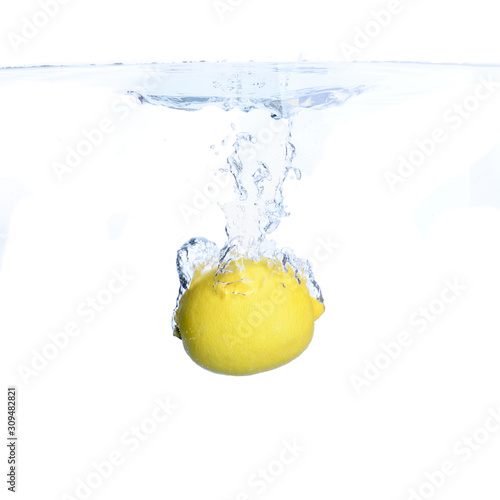 Lemons in the water with bubbles and splashes. Close-up. Isolated on white.Concept and idea with lemons