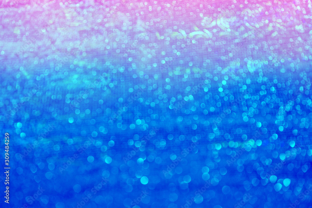 Blurred bokeh light blue pink holographic background, Christmas and New Year holidays abstract texture.