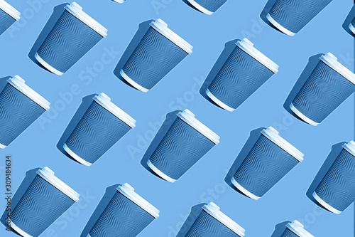 Coffee pattern of blue paper cup for coffee on bright classic blue background.