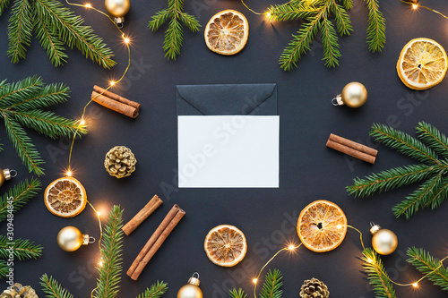 Beautiful christmas top view photo with empty white card in the center - mockup for your design and lots of festive decorations around