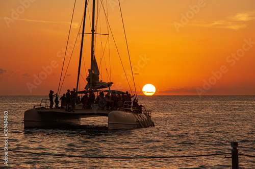 Obraz na plátně Catamaran sails at sunset